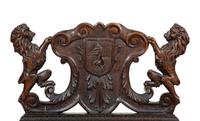 A Jacobean Style Carved Oak Bench with Armorial and Lion Carved Back