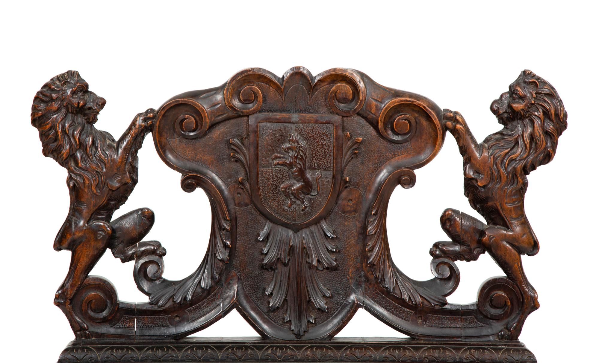 A Jacobean Style Carved Oak Bench with Armorial and Lion Carved Back
