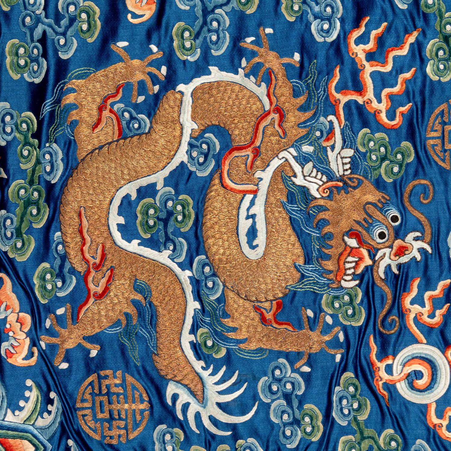 A Chinese Blue Ground Embroidered Silk 'Dragon' Robe, Jifu , 19th Century 清晚期 藍緞地綉云龍紋吉服