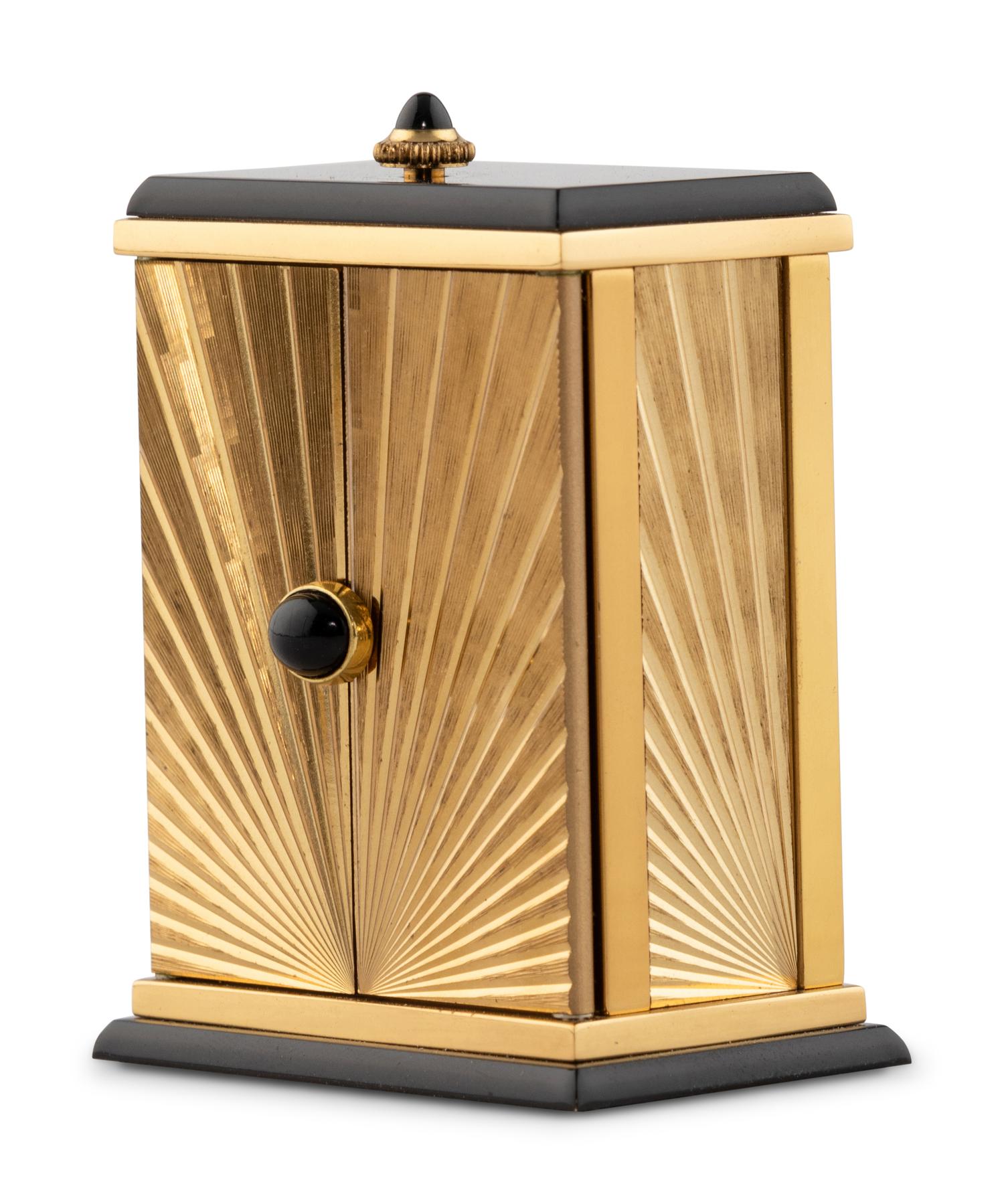 A Cartier Engraved Brass and Onyx Travel Clock