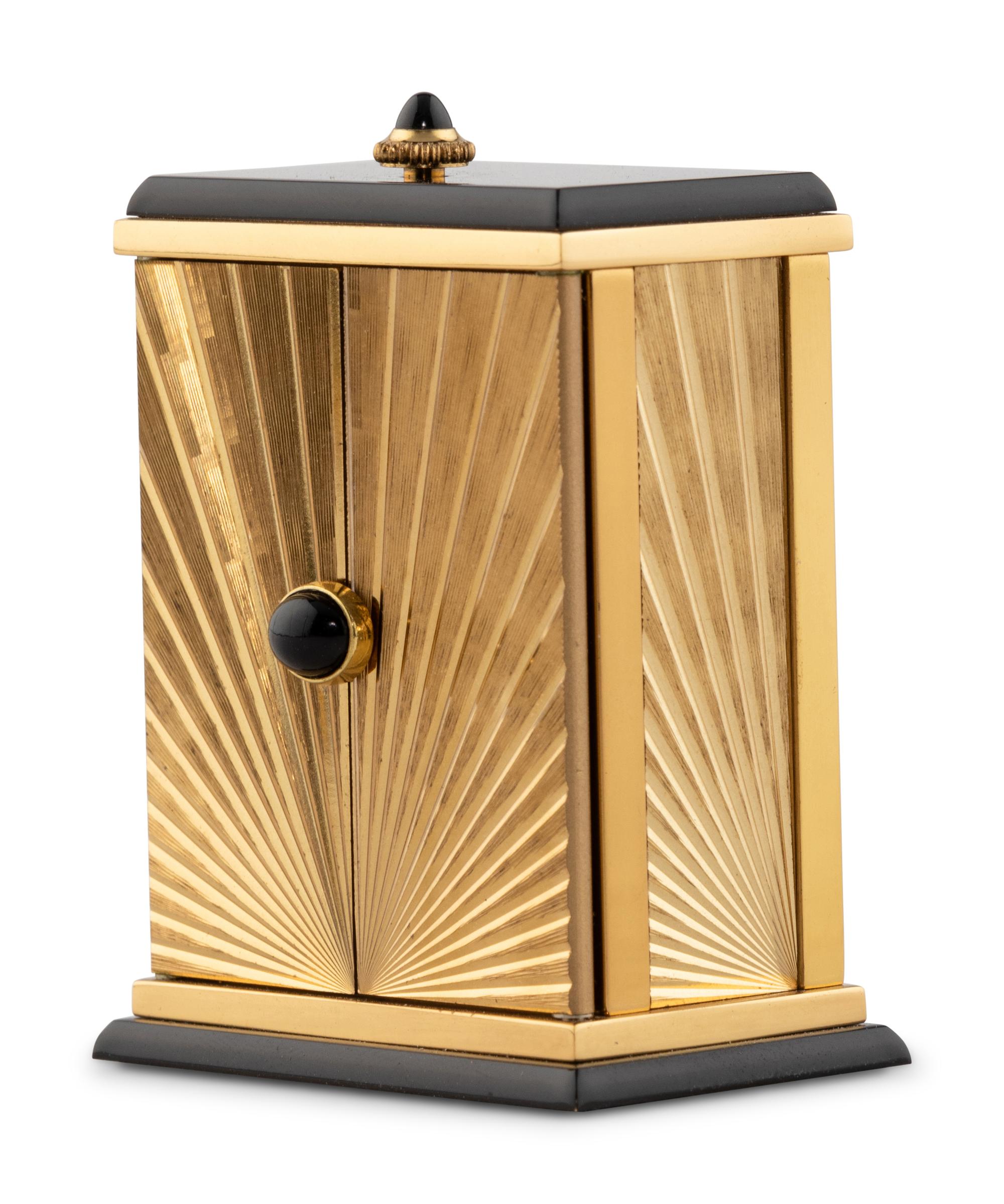 A Cartier Engraved Brass and Onyx Travel Clock