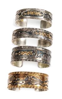Four Southwestern Silver Storyteller Bracelets Length of one 6 x opening 7/8 x width 5/8 inches