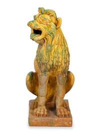A Pair of Italian Yellow and Green Glazed Ceramic Figures of Seated Lions