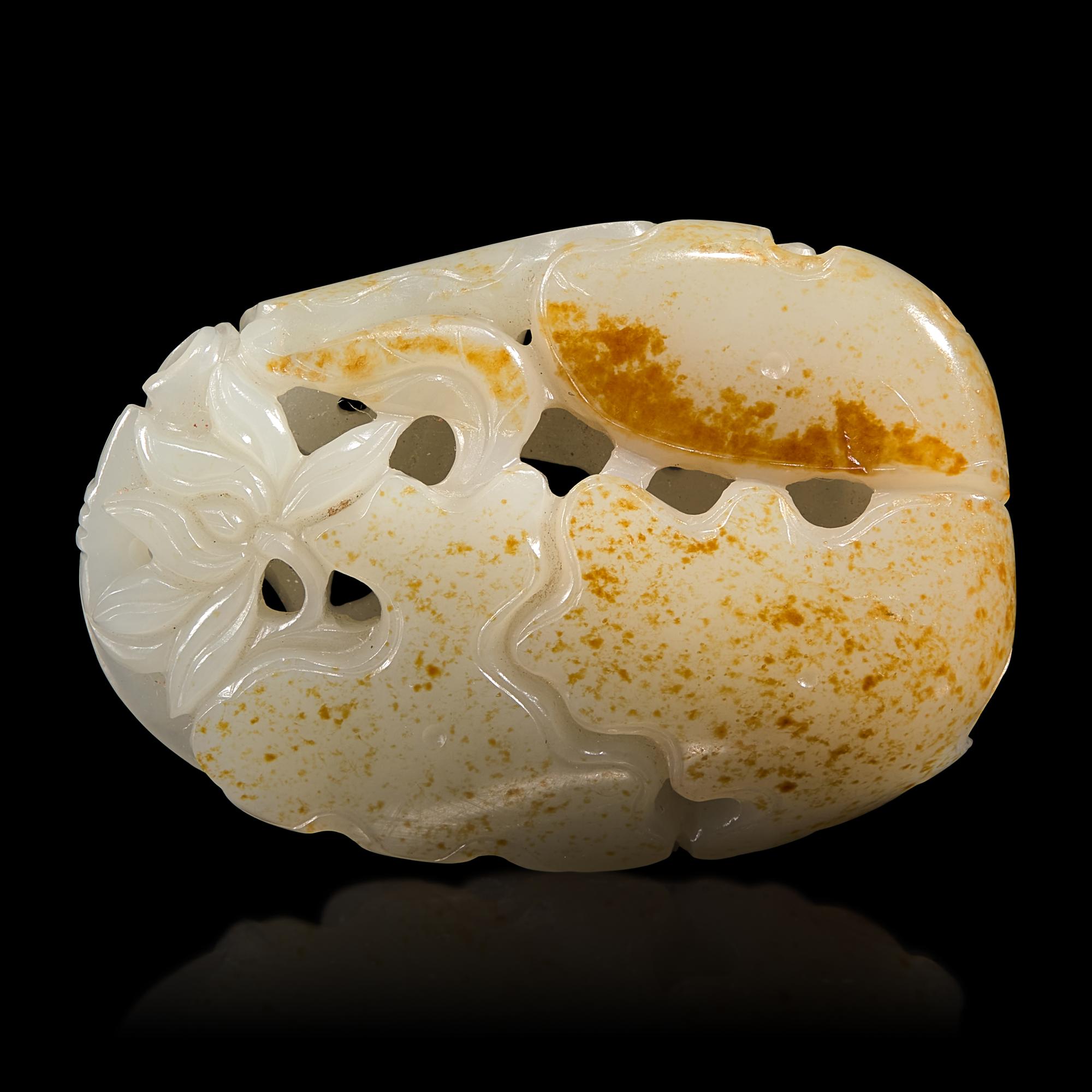 A Chinese White and Russet Jade 'Lotus' Pendant, 18th/19th Century — 清中期 白玉帶皮鏤雕蓮塘荷葉佩