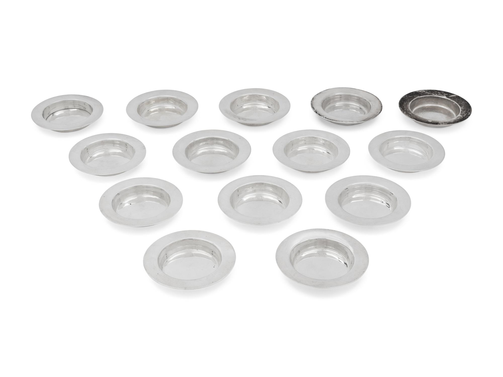 A Set of Fourteen English Silver Place-Setting Ash Trays