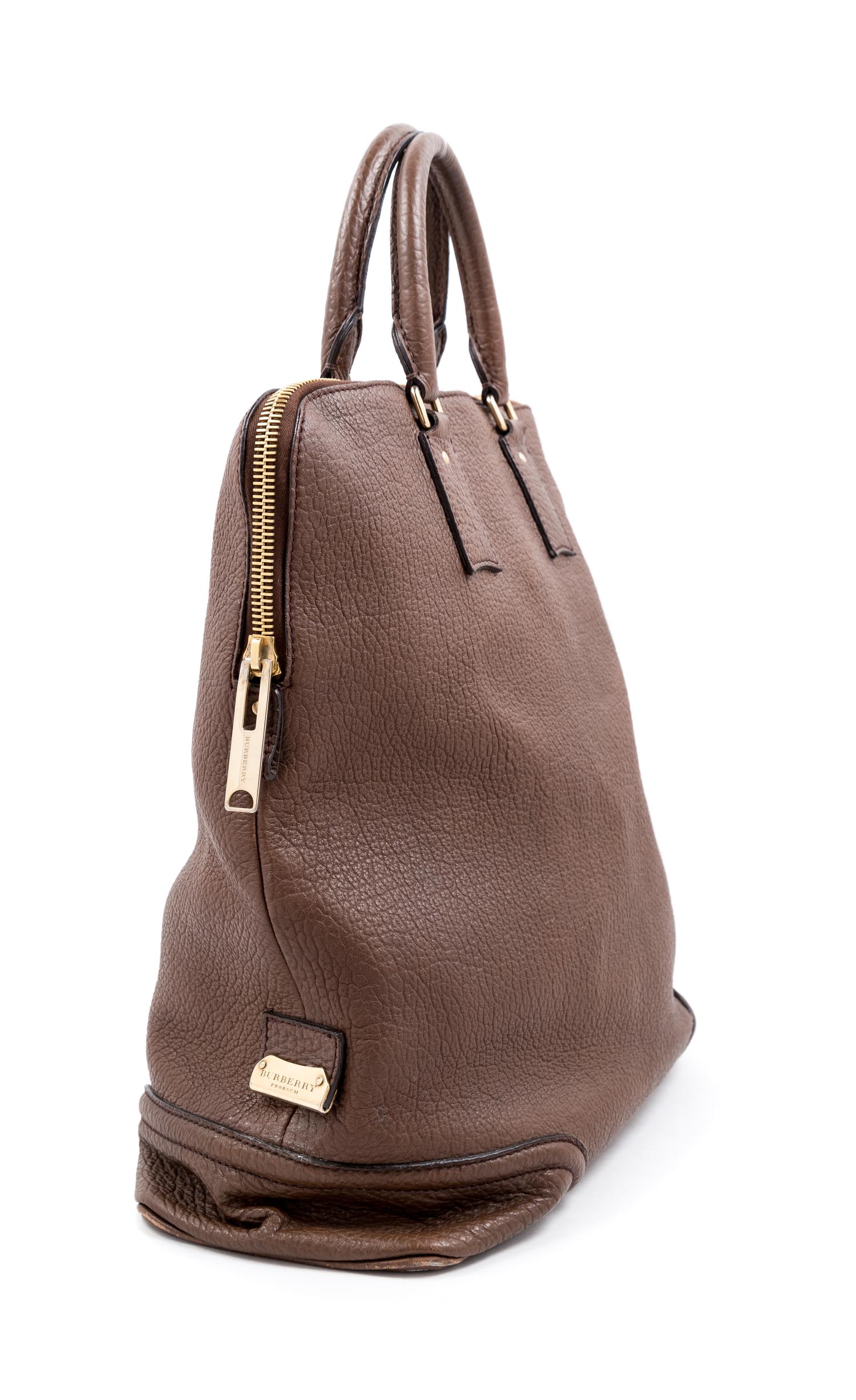 A Burberry Dark Brown Textured Leather Travel Bag, 17" H x 16" W x 6" D; Handle drop: 5".