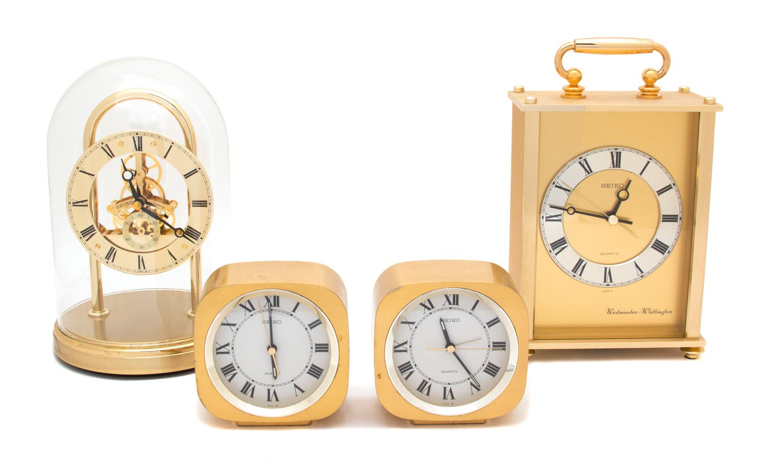 A Collection of Four Seiko Brass Quartz Clocks Height of tallest 9 3/4 inches. — 20TH CENTURY