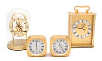 A Collection of Four Seiko Brass Quartz Clocks Height of tallest 9 3/4 inches. — 20TH CENTURY
