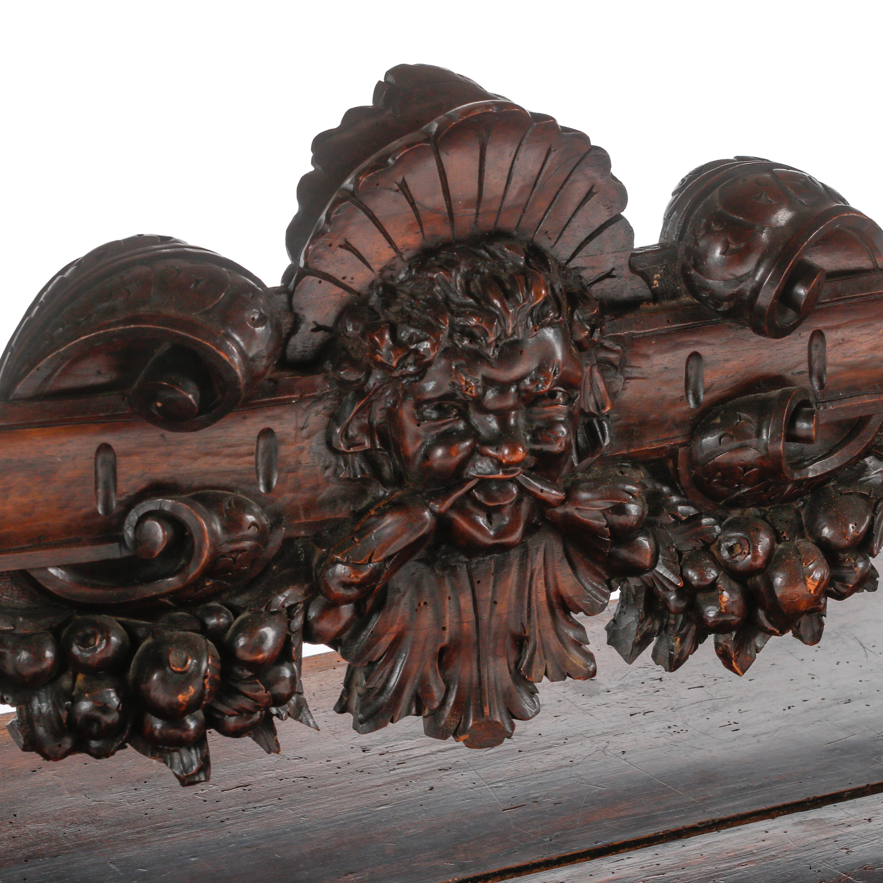 An Italian Renaissance Revival Carved Walnut Library Table