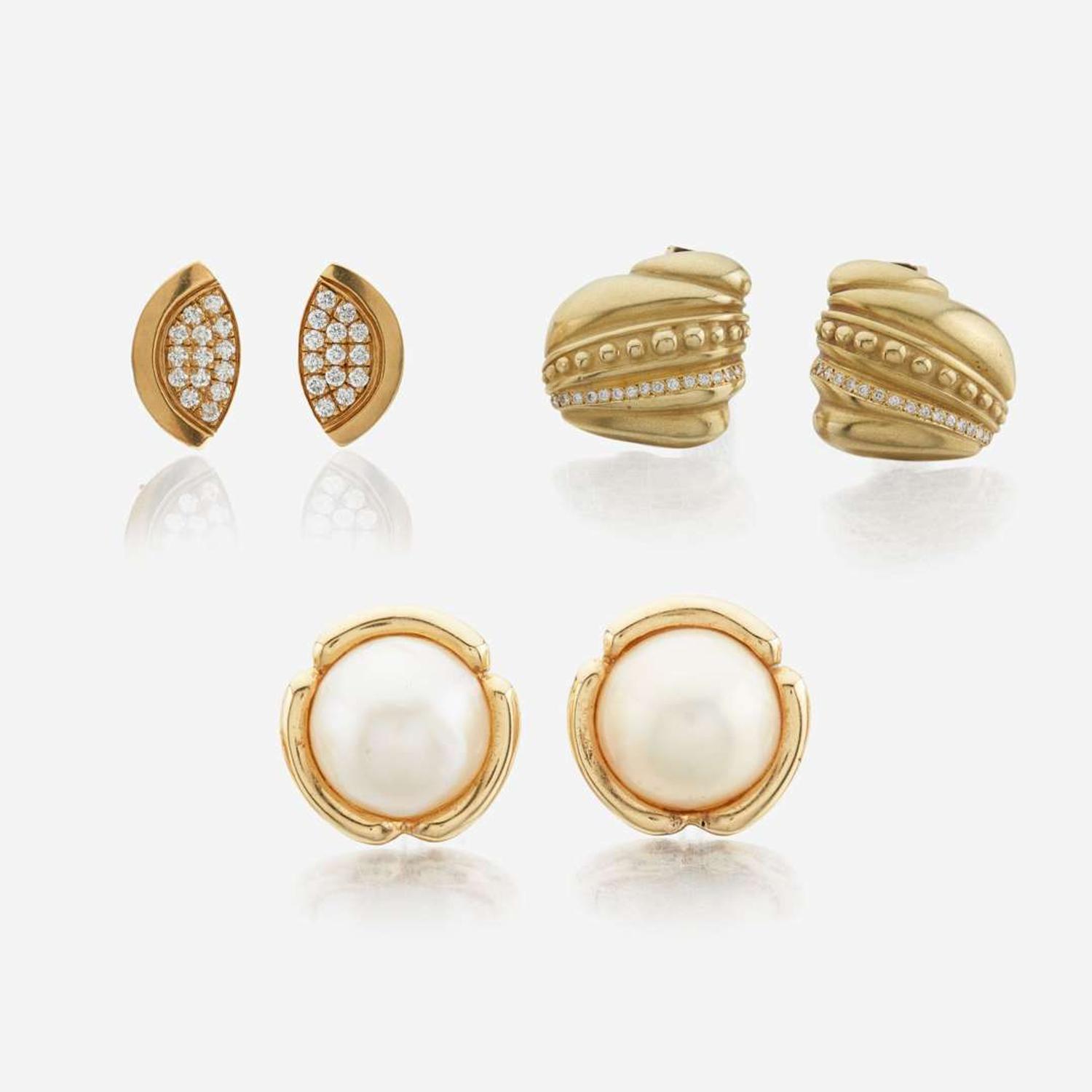 A collection of three gold and gem-set ear clips
