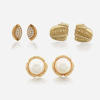 A collection of three gold and gem-set ear clips