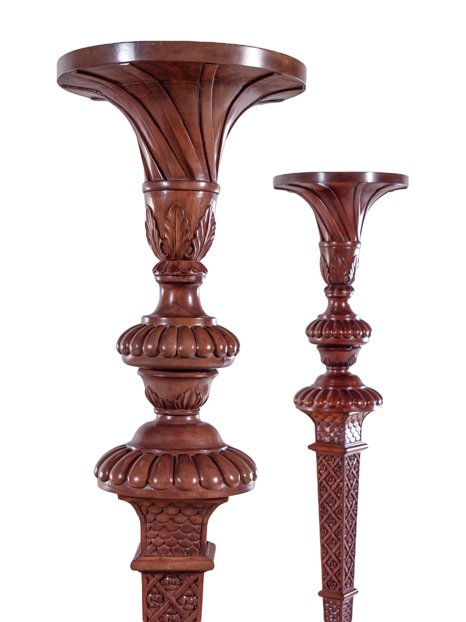 A Pair of Continental Carved Walnut Torchères