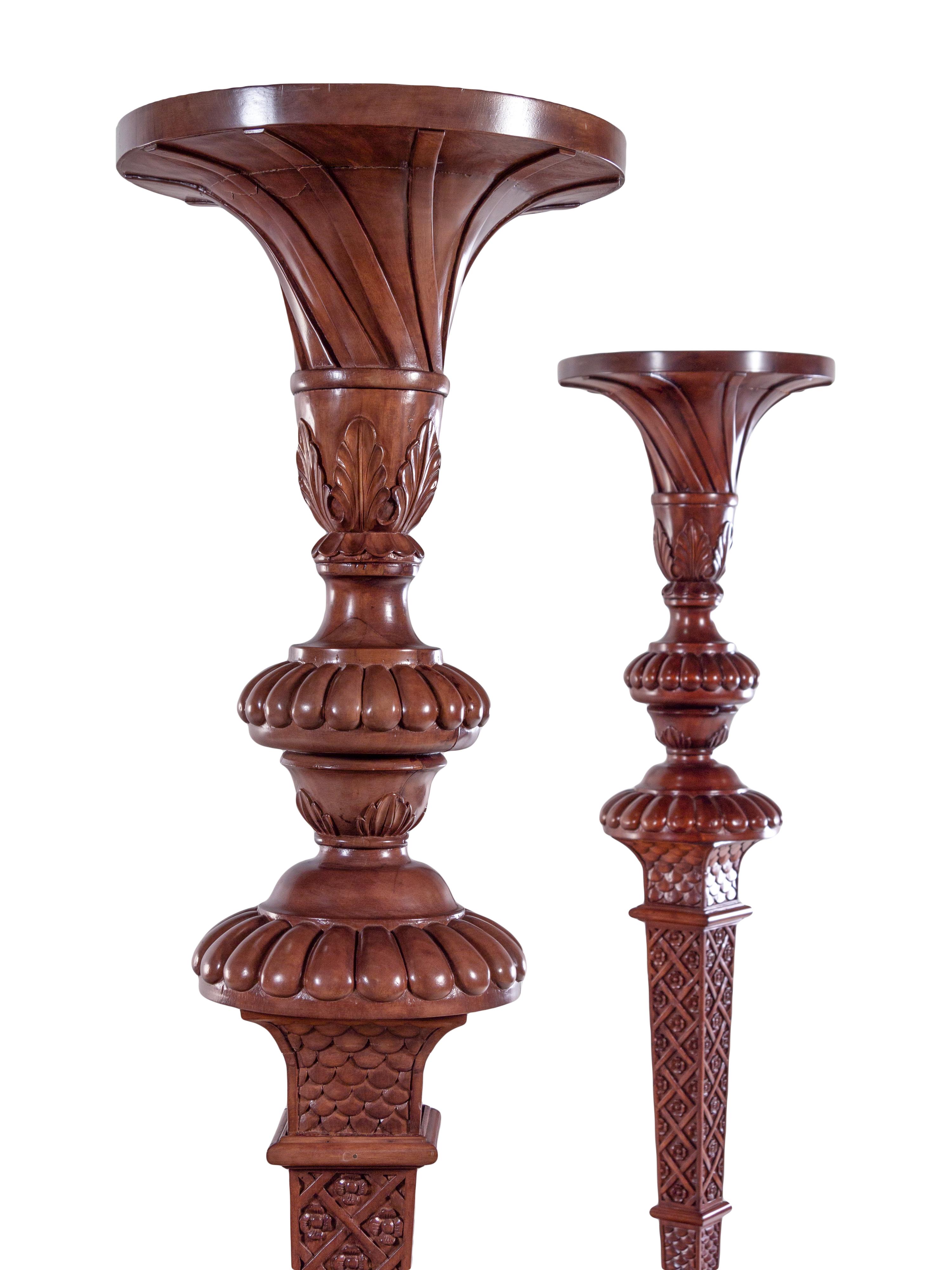 A Pair of Continental Carved Walnut Torchères