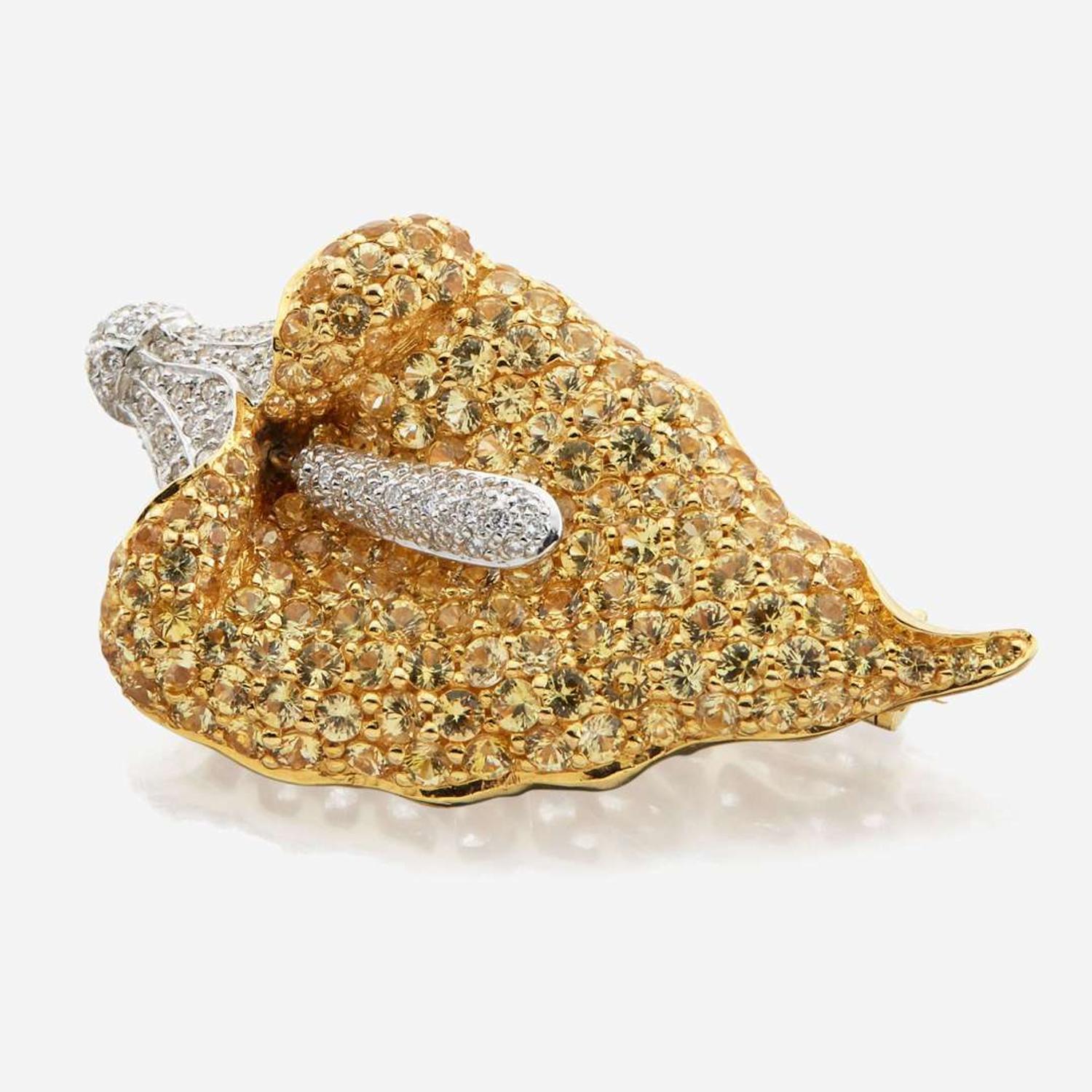 A diamond, sapphires, and white gold brooch
