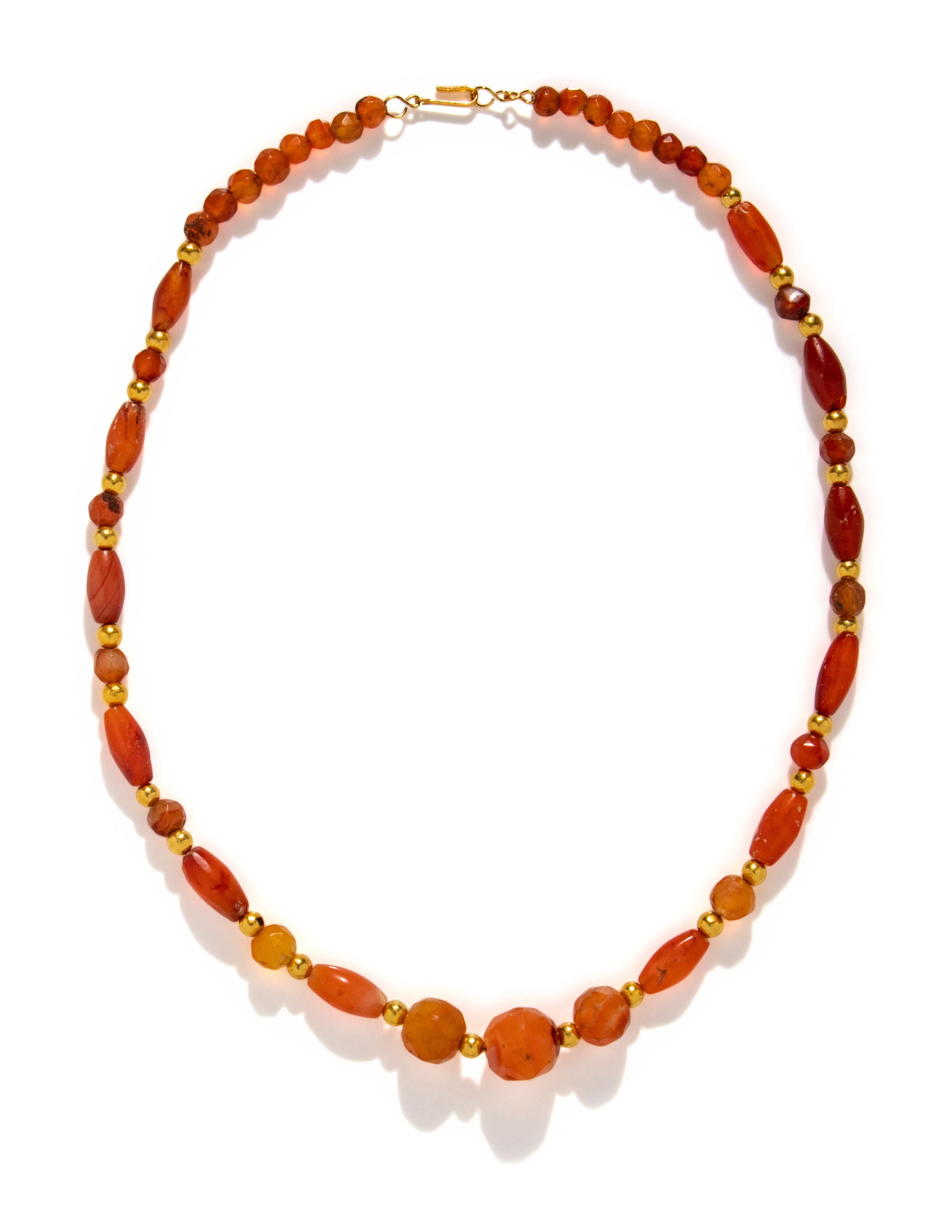A Near Eastern Gold and Carnelian Bead Necklace