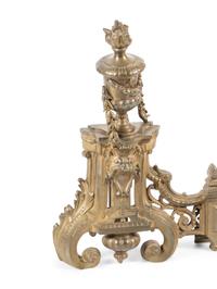 A Pair of Louis XVI Style Gilt Bronze Chenets with a Matching Fender