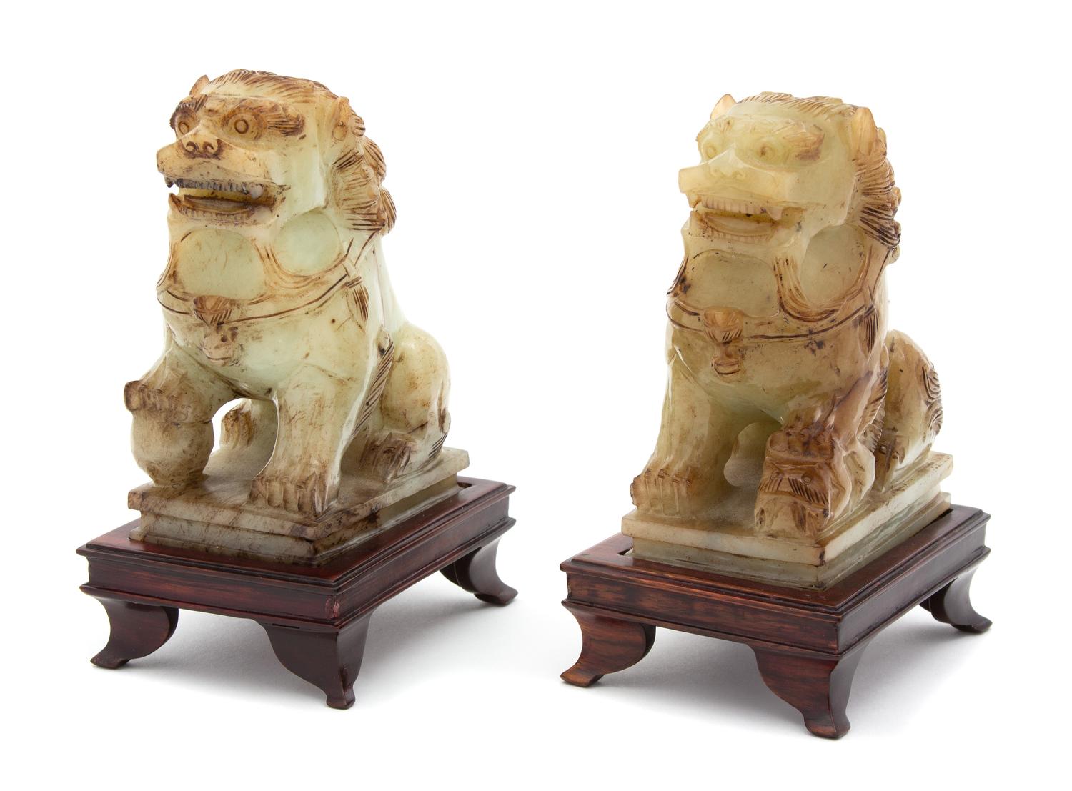 A Pair of Apple Green Jadeite Foo Lions Height 5 inches. — 20TH CENTURY