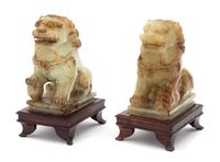 A Pair of Apple Green Jadeite Foo Lions Height 5 inches. — 20TH CENTURY
