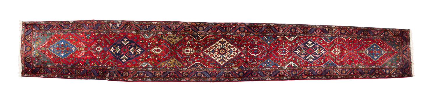 A Persian Wool Runner 19 feet 2 inches x 3 feet 5 inches. — 20TH CENTURY