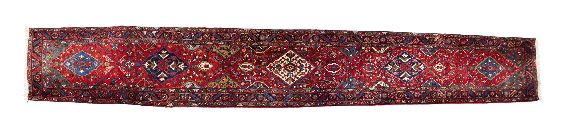 A Persian Wool Runner 19 feet 2 inches x 3 feet 5 inches. — 20TH CENTURY