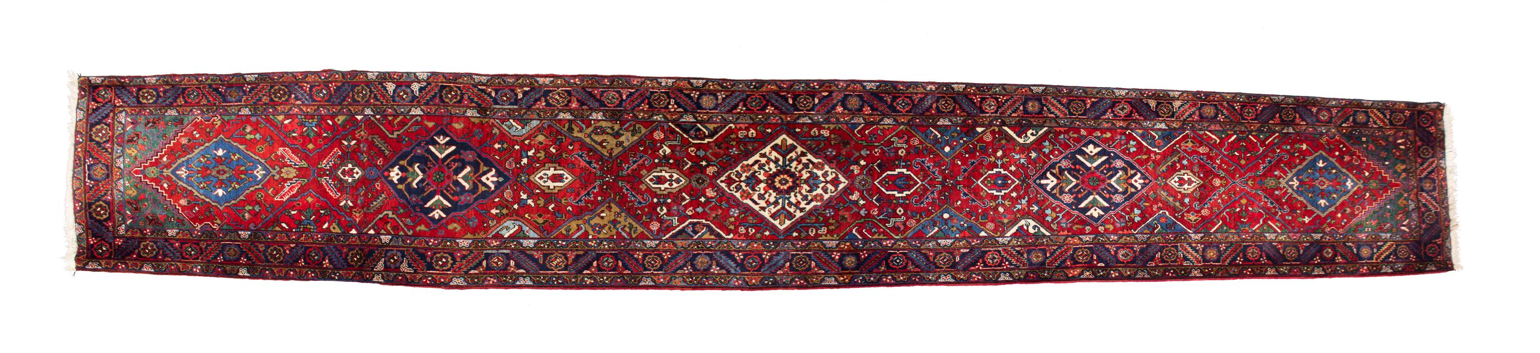 A Persian Wool Runner 19 feet 2 inches x 3 feet 5 inches. — 20TH CENTURY