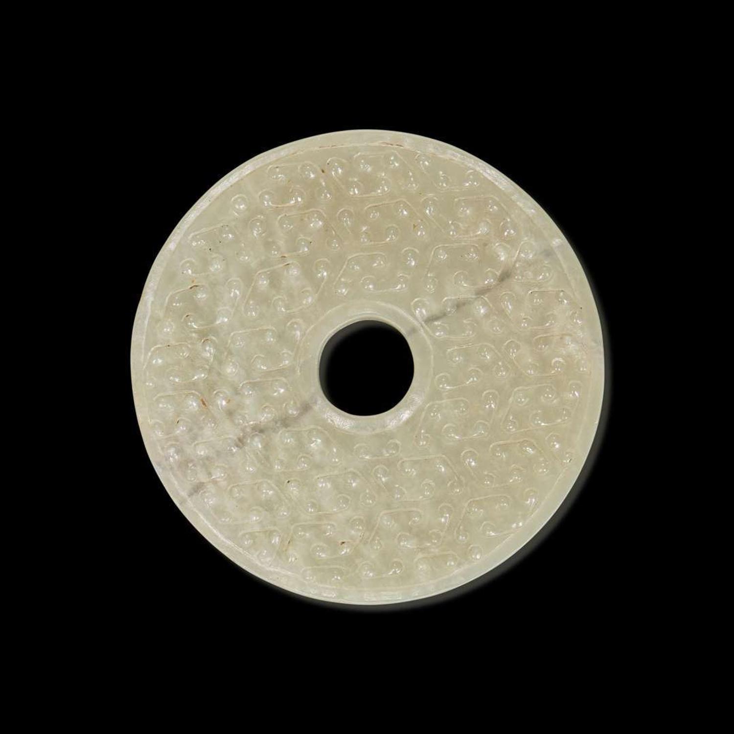 A Chinese greyish white jade archaistic bi disk 灰白玉璧