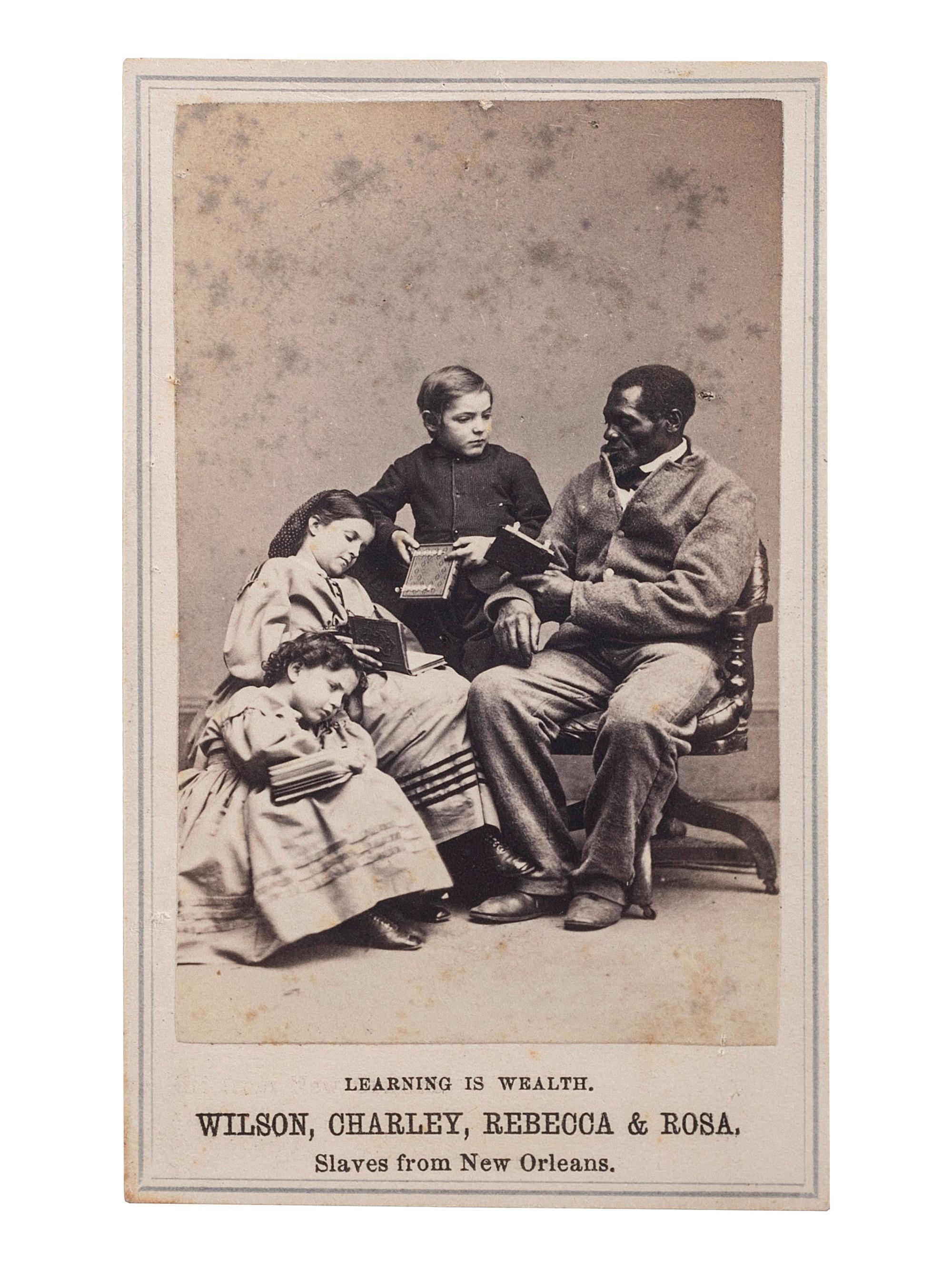 [SLAVERY & ABOLITION] -- [CHINN, Wilson]. PAXSON, Charles, photographer. Learning is Wealth. Wilson, Charley, Rebecca & Rosa . Slaves from New Orleans. New York: S. Tackaberry, 1864.