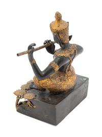 A Thai Gilt and Patinated Bronze Flute Player