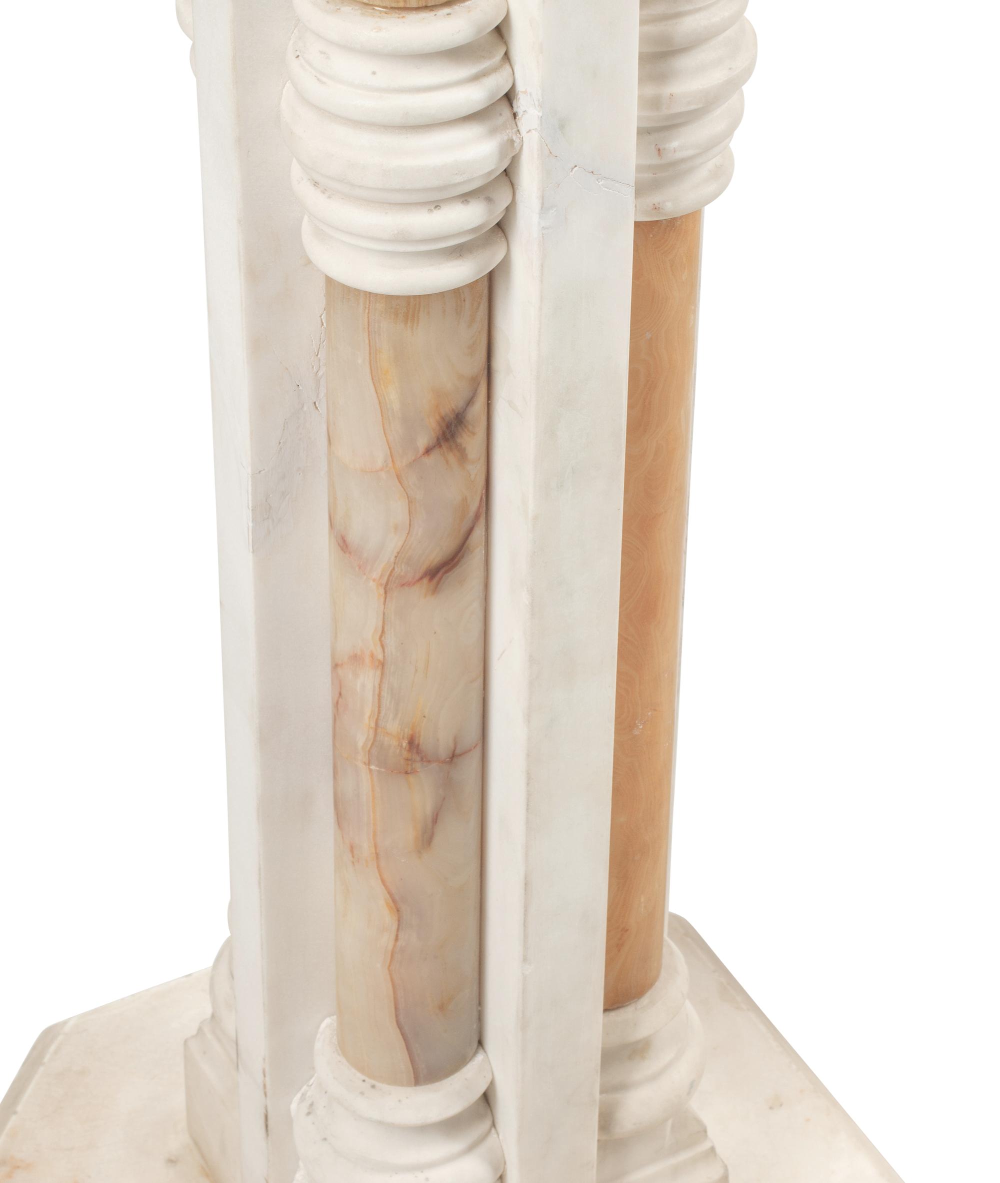A Pair of Continental Carved Marble and Onyx Quadripartite Pedestals