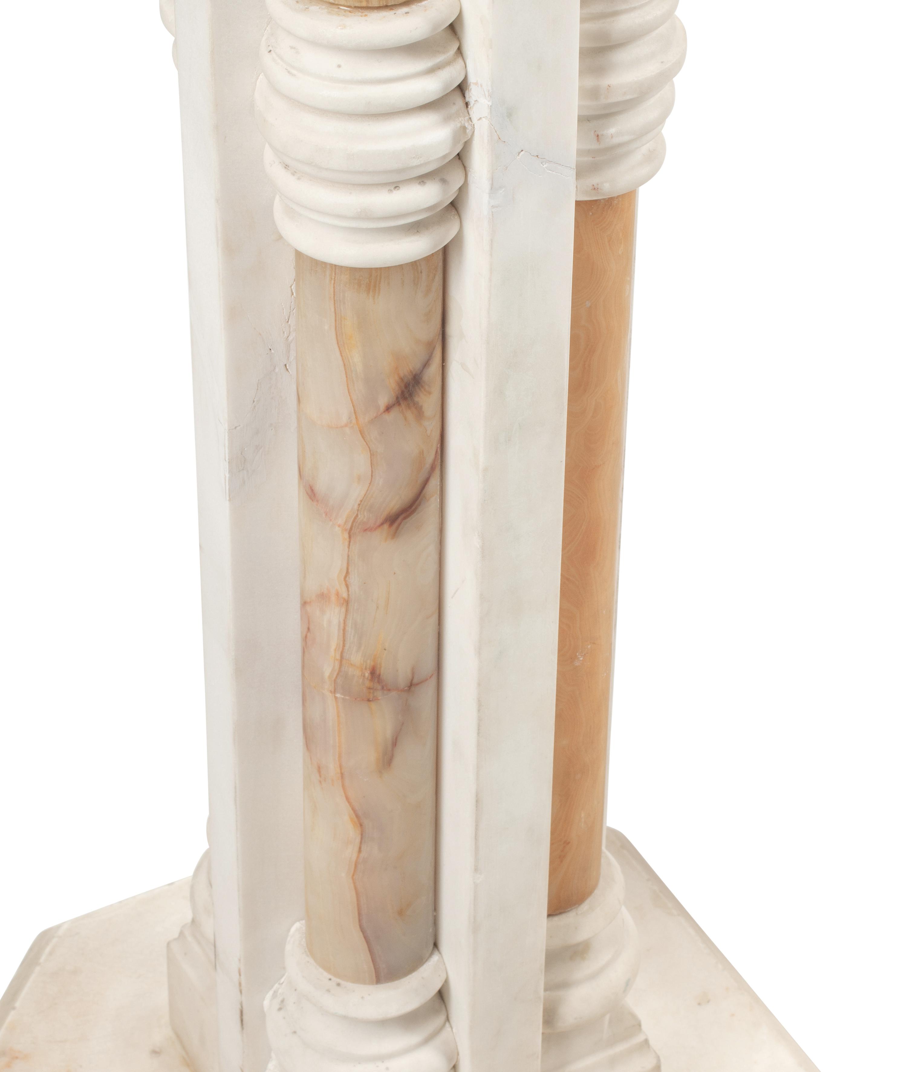 A Pair of Continental Carved Marble and Onyx Quadripartite Pedestals