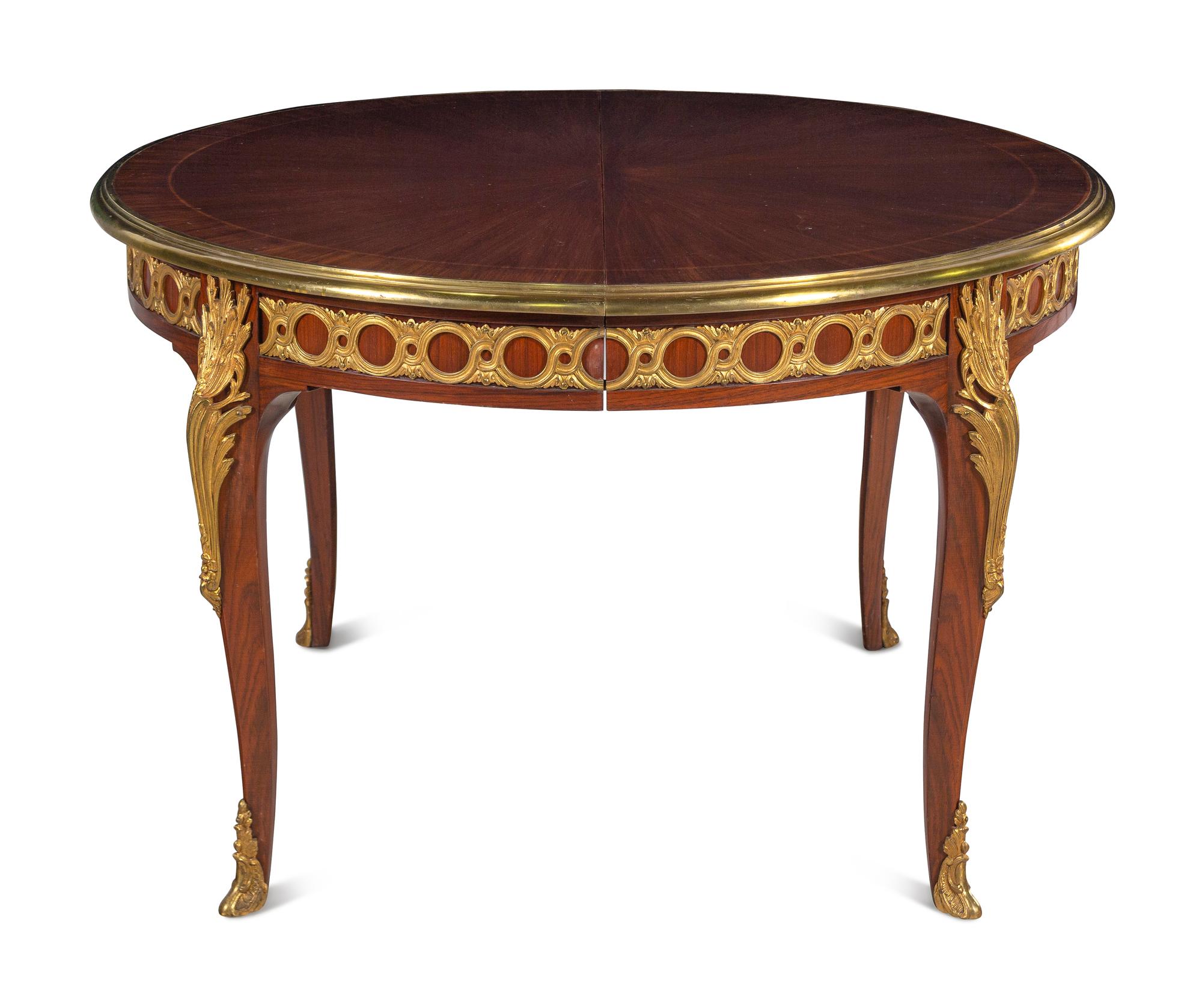 A Louis XVI Style Gilt Bronze Mounted Parquetry Dining Table