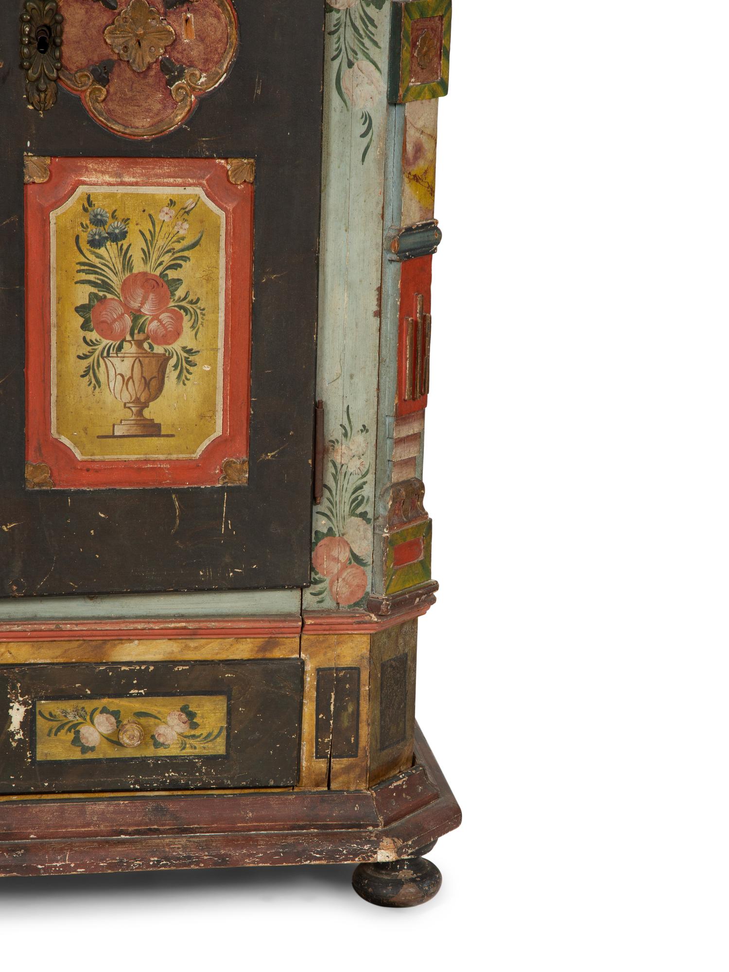 A Continental Carved, Painted and Parcel Gilt Pine Schrank