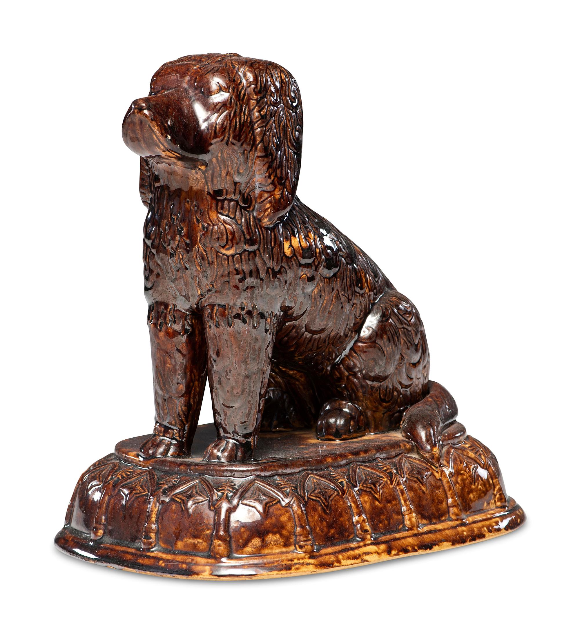 A Rare Rockingham Glazed Molded Yelloware Forward-Facing Dog