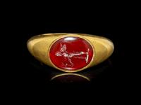 A Roman Gold and Garnet Finger Ring with the God Eros