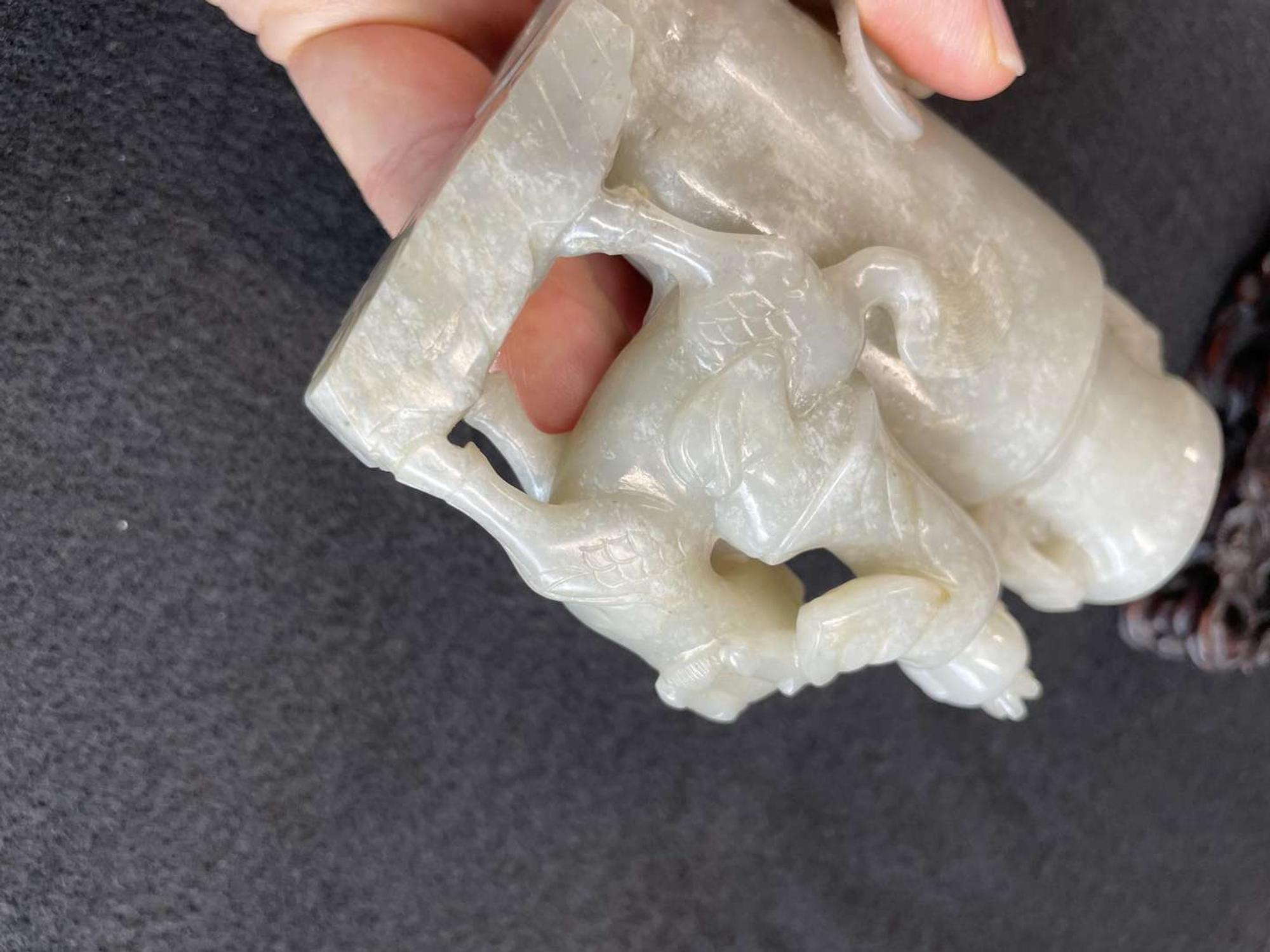 A Chinese jade "Boys, Kylin and Phoenix" vase on carved wood stand 玉雕童子凤鸟花樽及底座