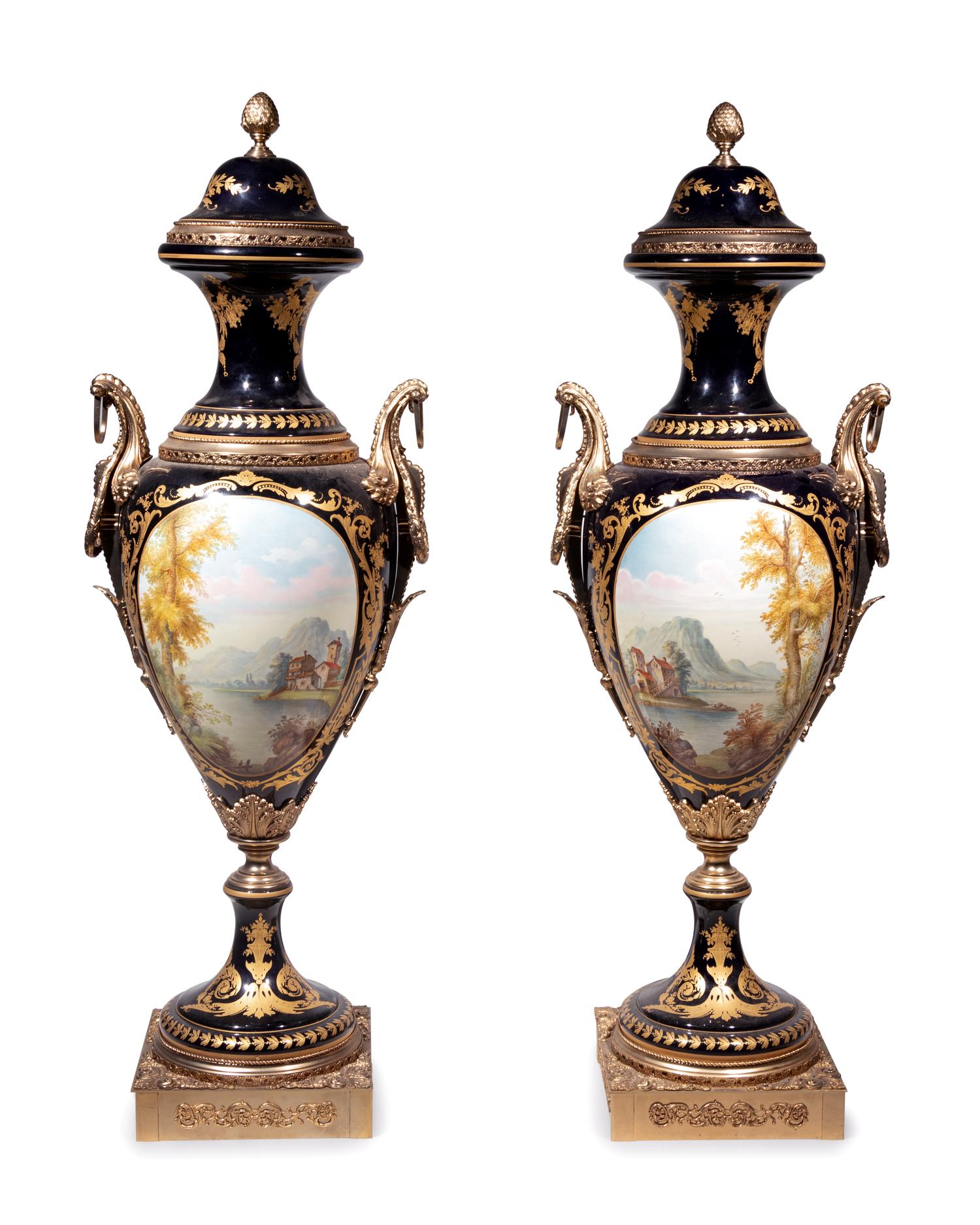 A Pair of Monumental Sèvres Style Gilt Metal Mounted Porcelain Covered Urns on Pedestals
