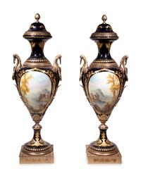 A Pair of Monumental Sèvres Style Gilt Metal Mounted Porcelain Covered Urns on Pedestals