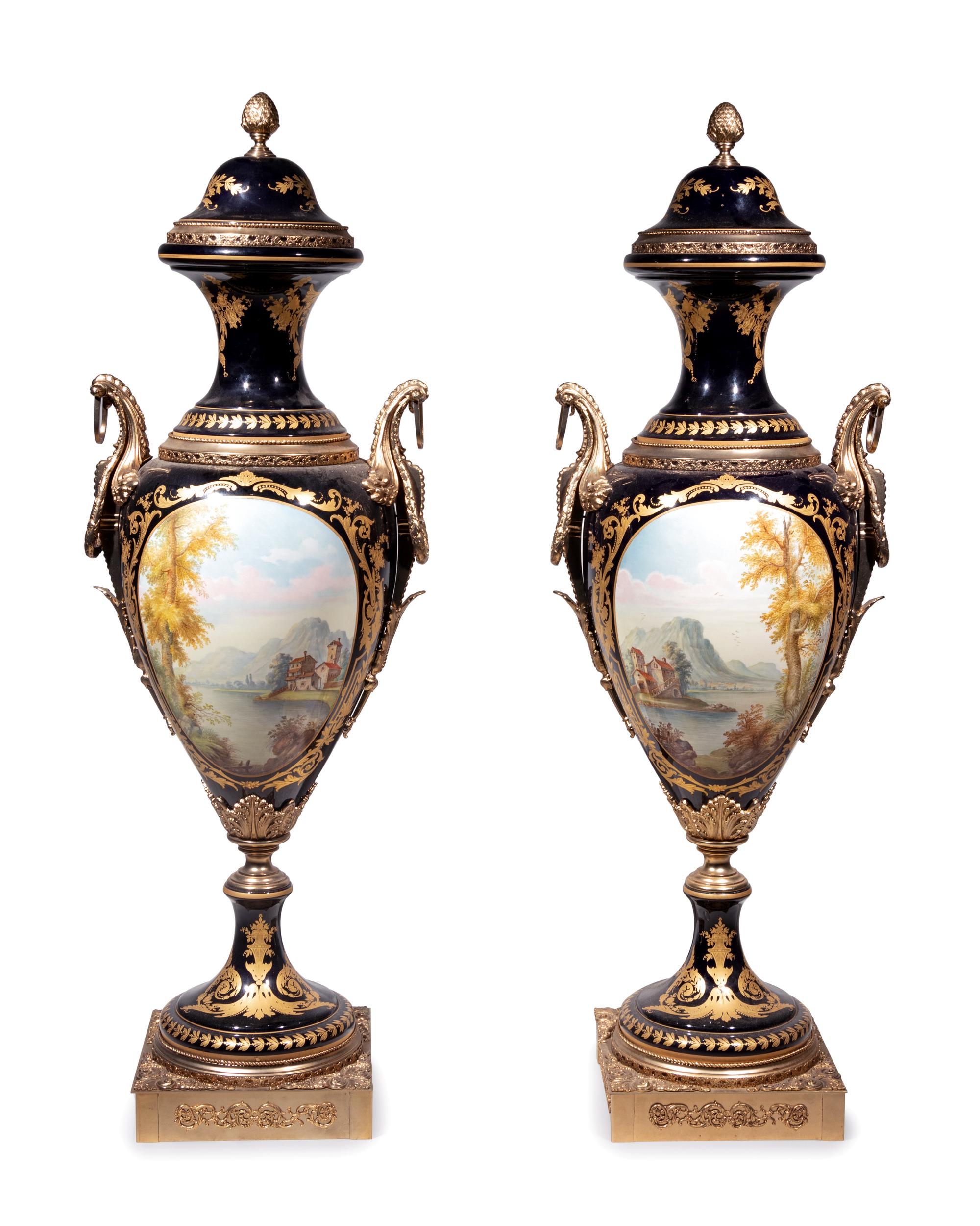 A Pair of Monumental Sèvres Style Gilt Metal Mounted Porcelain Covered Urns on Pedestals
