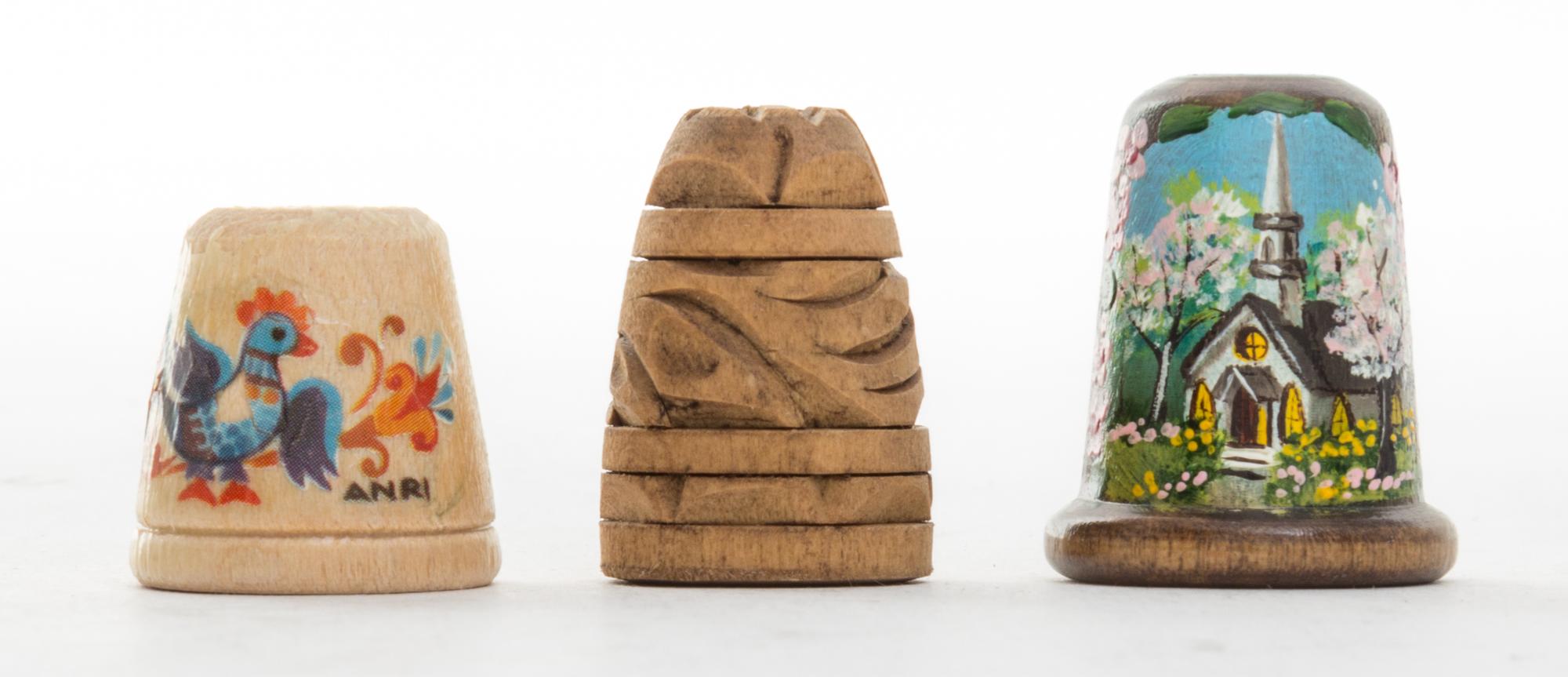 A Collection of Three Wood Thimbles Height of tallest 1 1/8 inches.