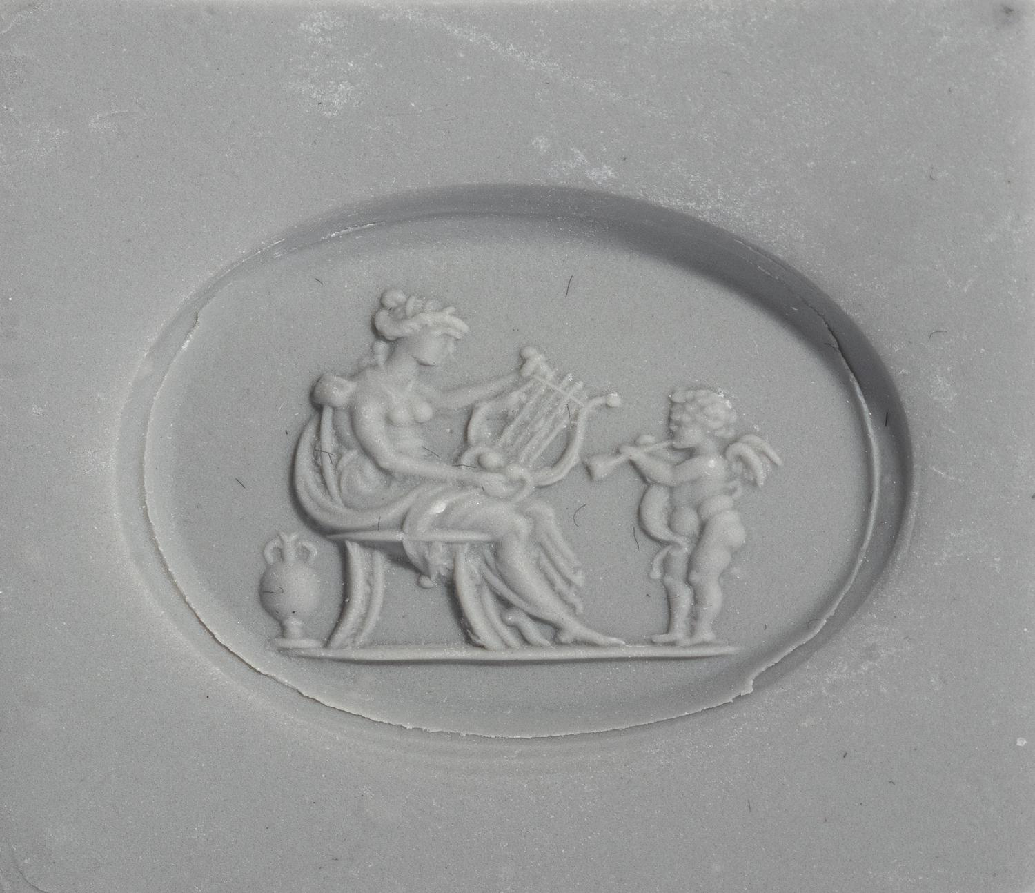A Neoclassical Gold and Carnelian Finger Ring with a Muse Playing a Harp