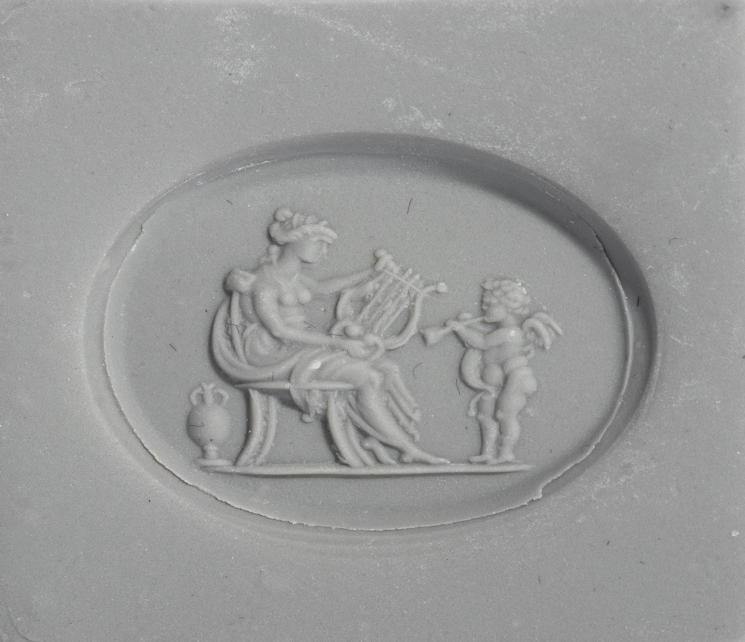 A Neoclassical Gold and Carnelian Finger Ring with a Muse Playing a Harp