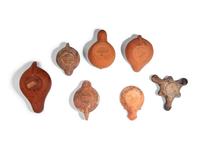 Ten Roman Terracotta Oil Lamps and a Holy Land Pottery Jug