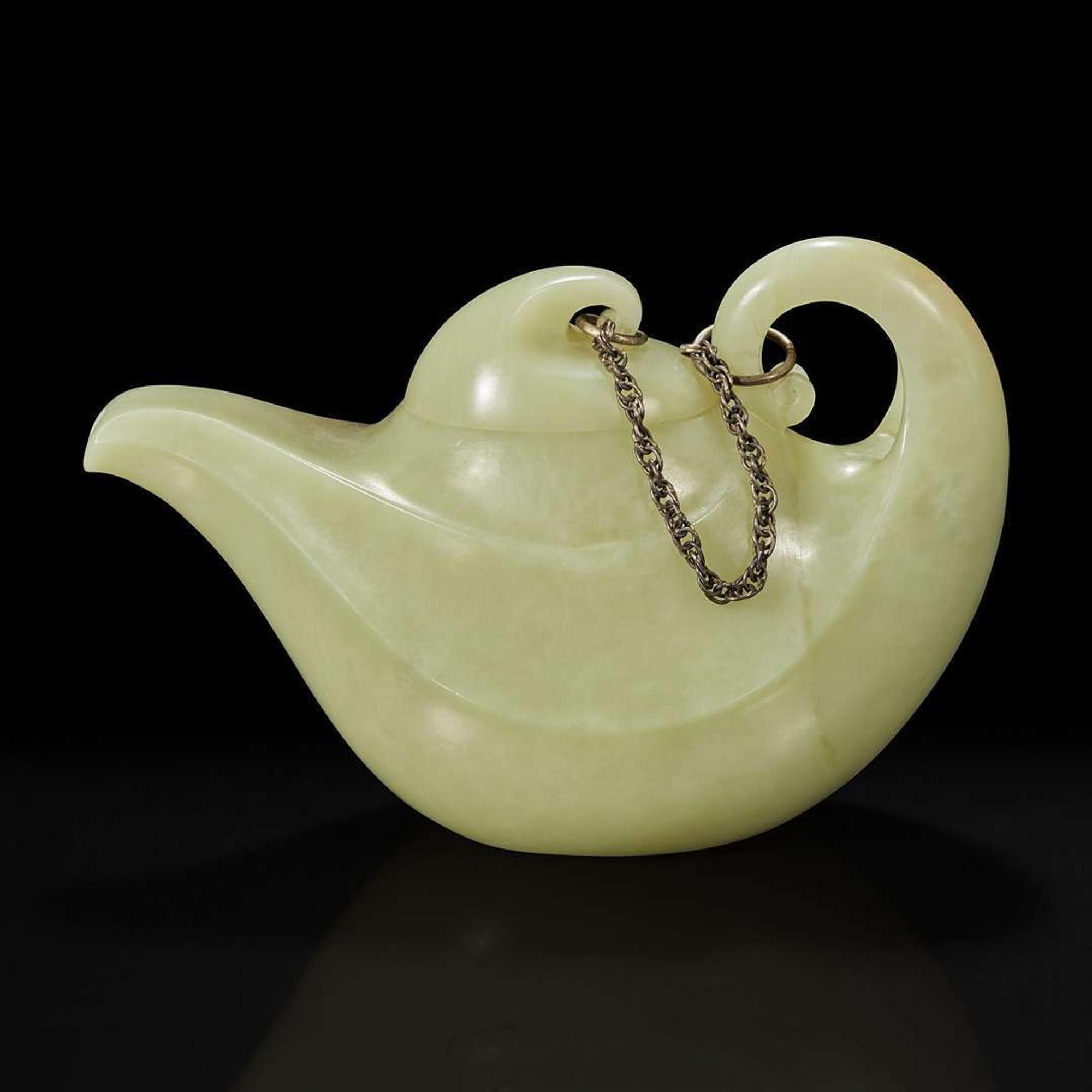 A Chinese yellowish-celadon jade teapot and cover 青黄玉雕带盖茶壶