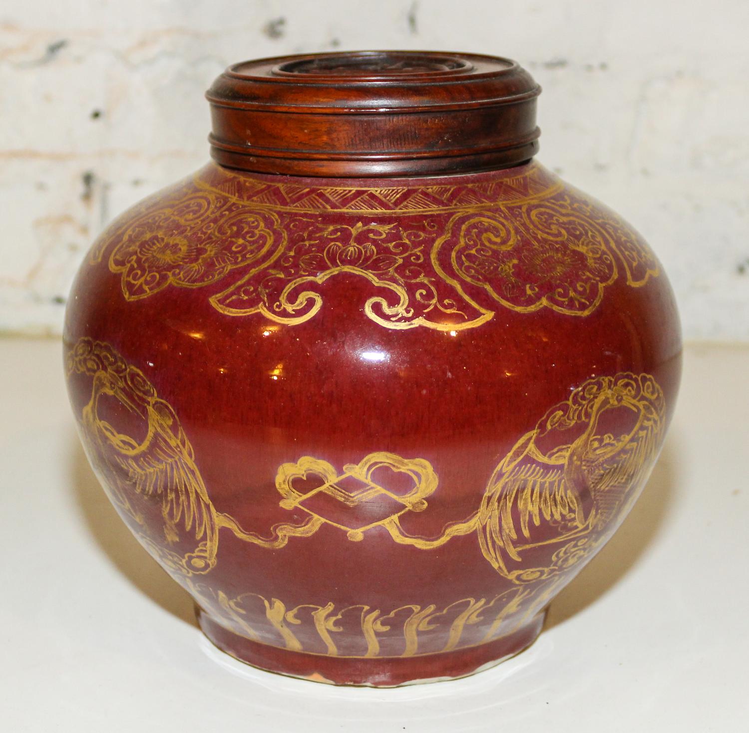 A Gilt Decorated Red Glazed Ginger Jar. Height 8 1/4 inches.