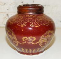 A Gilt Decorated Red Glazed Ginger Jar. Height 8 1/4 inches.