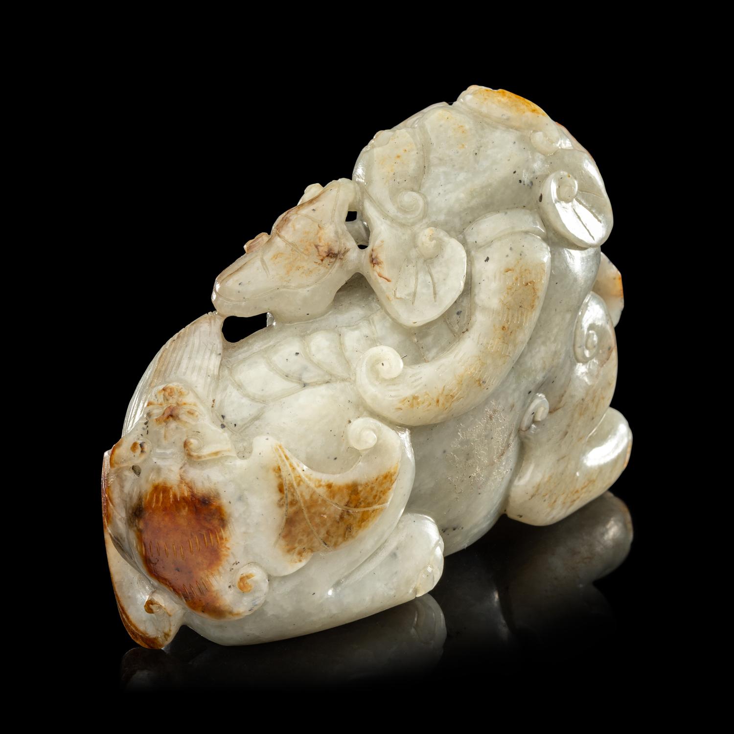 A Chinese Russet and Greyish Celadon Jade Figure of a Recumbent Qilin 青玉麒麟