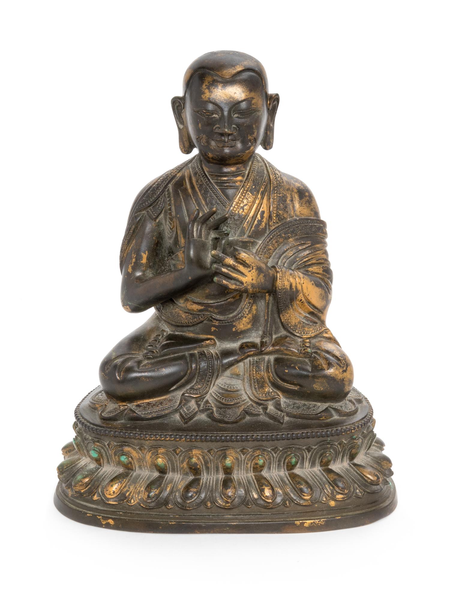 A Sino-Tibetan Parcel Gilt Bronze Figure of Guru Height 8 inches. — MING DYNASTY (1368-1644)