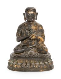 A Sino-Tibetan Parcel Gilt Bronze Figure of Guru Height 8 inches. — MING DYNASTY (1368-1644)