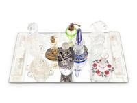 A Collection of Eleven Glass Perfume Bottles and a Mirrored Glass Tray