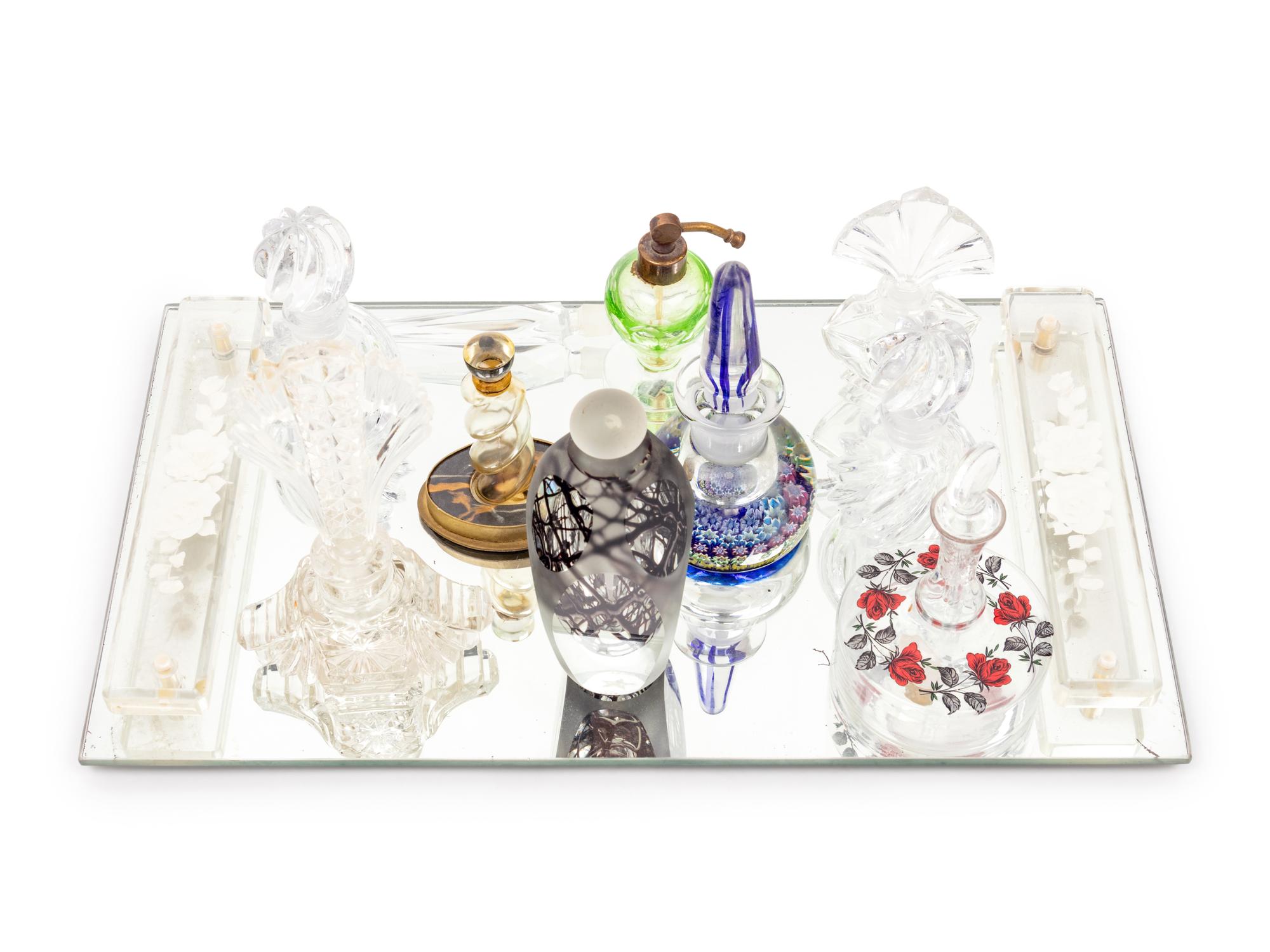 A Collection of Eleven Glass Perfume Bottles and a Mirrored Glass Tray